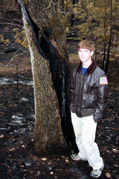 Ben by Oak tree hollowed out by fire.